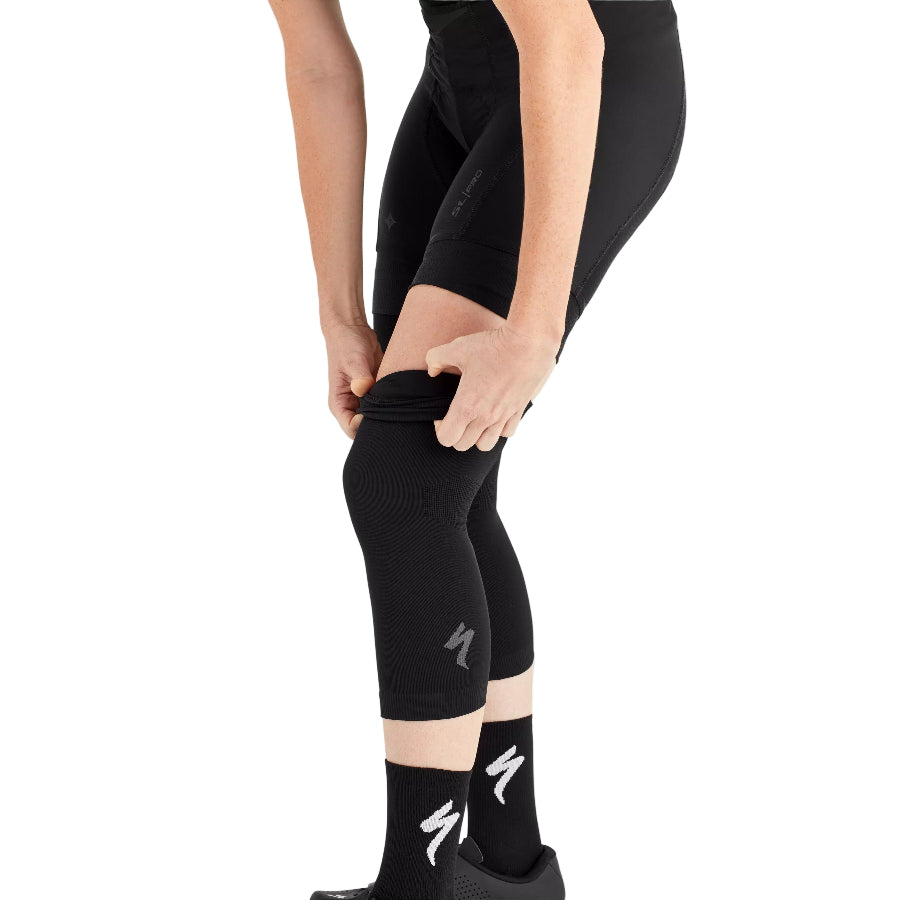 Person wearing black leggings with a brand logo on a white background