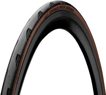 Close-up of a bicycle tire with a brown sidewall on a white background