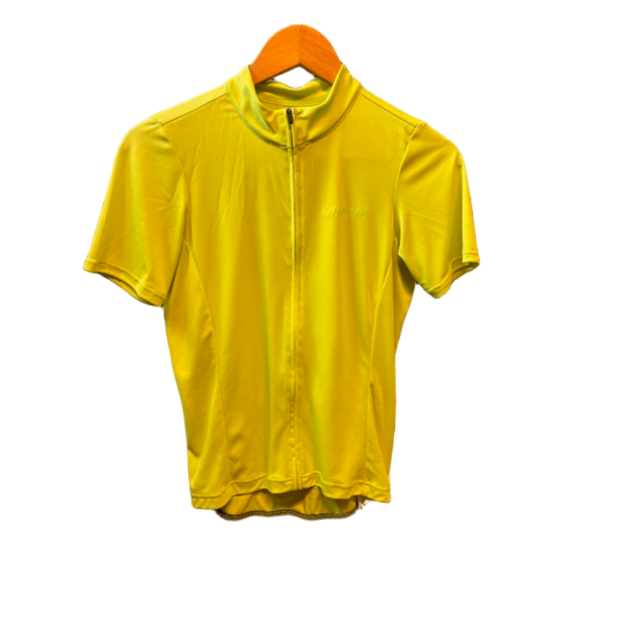 Yellow short-sleeve jacket on a hanger in front of a dryer