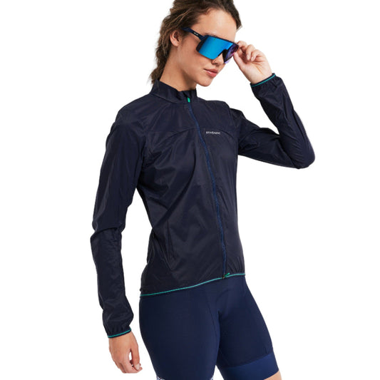 Woman wearing a navy blue PEPPERMINT CYCLING WIND JACKETand leggings with sunglasses on a white background
