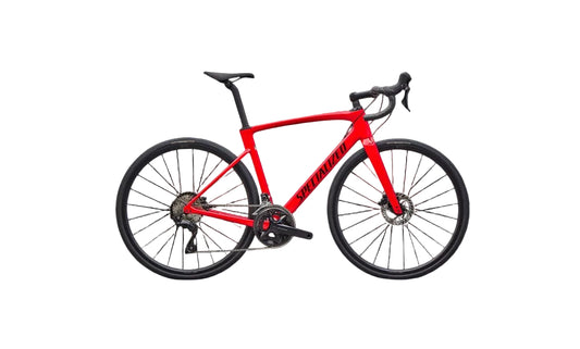 Red bicycle with black components on a black background