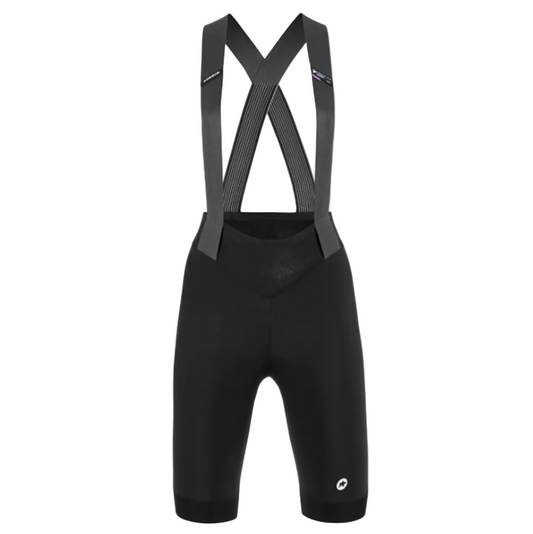 Black cycling bib shorts with suspenders on a light gray background