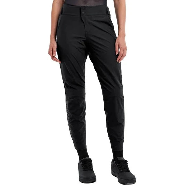 Black Peppermint Cylying MTB pants worn by a person on a white background.