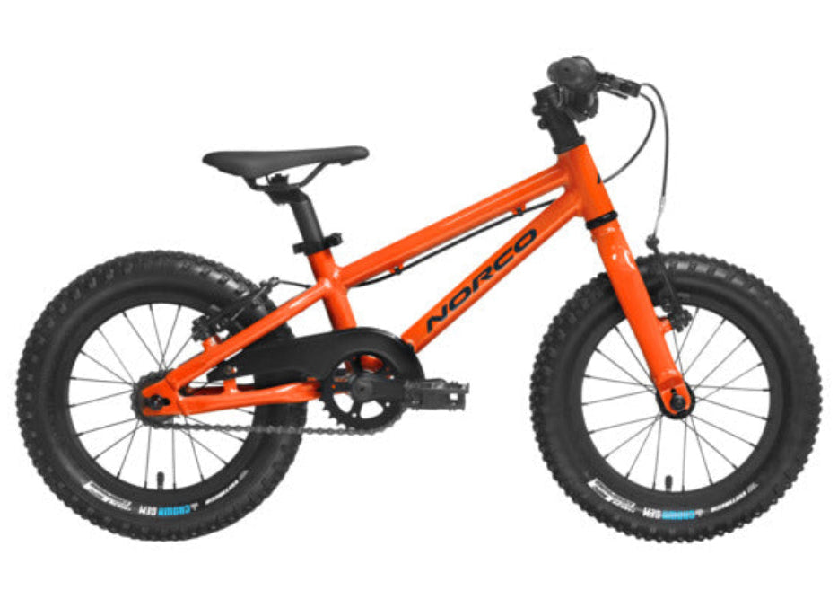 Orange children's bicycle with black tires on a white background